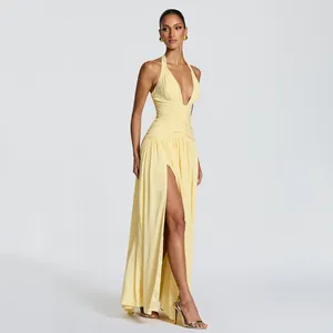 Elegant yellow halter neck evening dress featuring a high leg slit and ruched waist