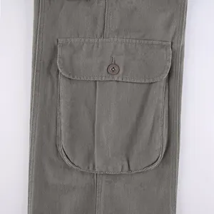 Close-up detail of a large cargo pocket with button on vintage straight-leg cotton pants.