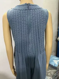 Detailed back view of sleeveless pleated washed denim jumpsuit with back zipper closure