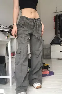 Detailed shot of vintage grey cargo pants featuring multiple pockets and a wide-leg fit
