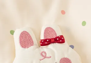 Detail of a children's windbreaker featuring a cute 3D bunny design with polka dots.