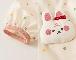 Close-up detail of polka dot jacket cuff and 3D rabbit patch decoration