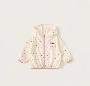 Close-up detail of girls' colorful polka dot hooded windbreaker with cute bunny patch