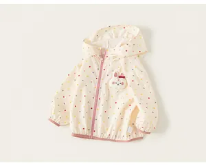 Detail of girls' cream hooded windbreaker with colorful polka dots and bunny applique
