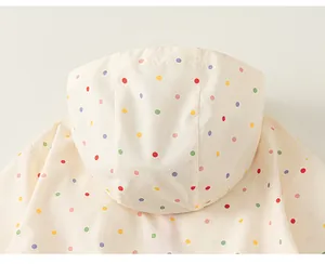 Detail shot showing the hood and colorful polka dot pattern of this girls windbreaker