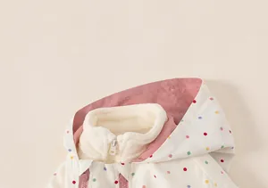 Close-up of toddler girl windbreaker with polka dots and soft fleece collar