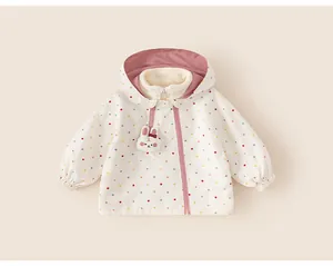 Close-up of girls' hooded windbreaker jacket with colorful polka dots and bunny zipper
