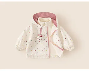 Close-up of girls' white polka dot hooded windbreaker jacket with cute bunny detail