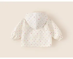 Back view of a white children's hooded windbreaker with colorful polka dots