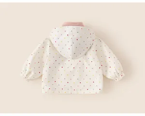 Detailed back view of a white girls' hooded windbreaker with colorful polka dots.