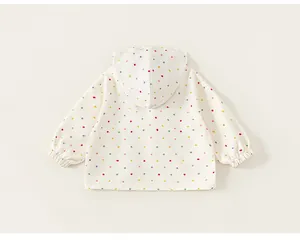 Back view of colorful polka dot hooded windbreaker for girls in off-white fabric.