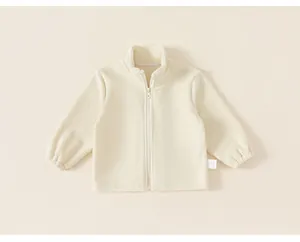 Close-up of cream children's fleece jacket showing soft texture and zipper detail
