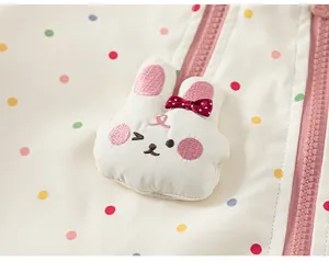 Close-up detail of cute 3D bunny embroidery on girls' polka dot windbreaker jacket