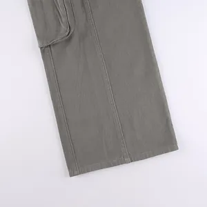 Detailed macro view of vintage grey cargo pants with wide-leg opening and flap pocket.