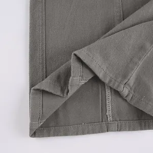 Close-up detail of durable double-stitched hem on vintage grey cargo pants fabric texture