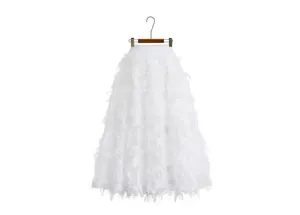 Detailed view of a white leaf cutout textured midi skirt shown on a wooden hanger