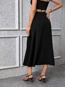 Vista trasera de una elegante falda midi negra de corte en A y talle alto con caída fluida