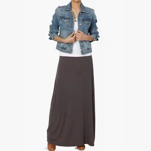 Close-up of a charcoal grey high-waisted maxi skirt with elegant drape on model