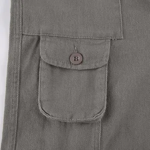 Close-up showing the durable fabric texture and pocket button detail of grey cargo pants