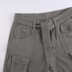 Detailed view of women's vintage cargo pants featuring multi-pockets and a matching belt