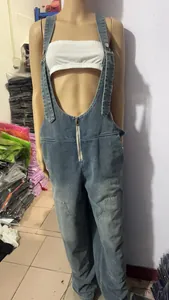 Close-up detail of women's loose casual denim overalls with a front zipper on a mannequin