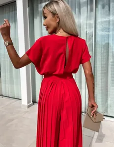 Elegant red pleated wide-leg jumpsuit featuring a back cutout and waist belt detail
