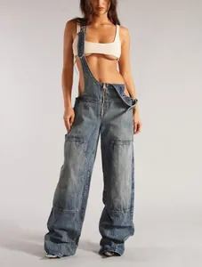 Full view of loose fit blue denim overalls with front zipper and wide legs