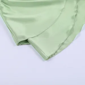 Close-up detail of the smooth satin hemline on this mint green A-line summer dress