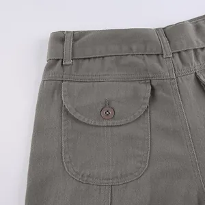 Close-up detail of the buttoned flap pocket and waist of grey vintage women's cargo pants
