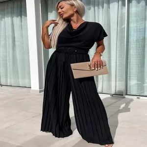 Detailed view of an elegant black pleated wide-leg jumpsuit featuring a matching belt