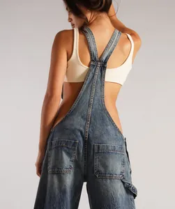 Detailed rear view of loose-fitting denim overalls showing back pockets and side zipper.