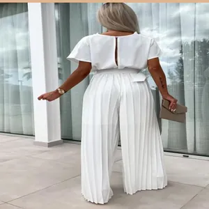 Back view of elegant white pleated wide-leg jumpsuit with belt and slit back detail.