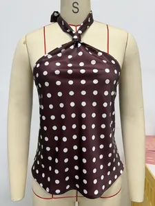 Detailed macro shot of a brown polka dot halter neck top on a mannequin display