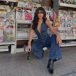 Street style shot showing a slim fit sleeveless denim jumpsuit with high waist design