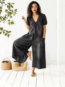 Casual dark wash denim wide-leg jumpsuit with V-neck tie-front and puff sleeves