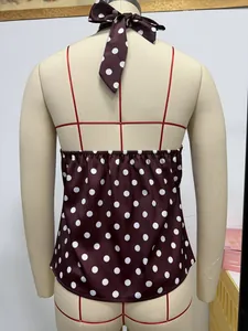 Detailed back view of a chic polka dot halter top on a mannequin with tie-neck detail.