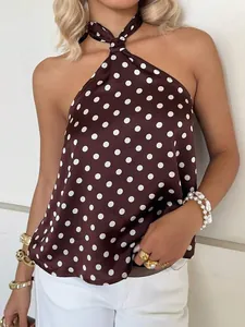 Close-up shot of an elegant brown and white polka dot halter top in silky satin fabric