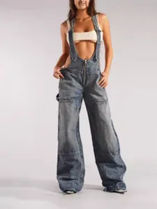 Fashionable distressed denim overalls featuring a front zipper and wide leg loose fit design