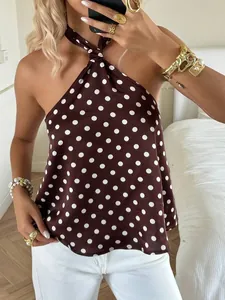 Close-up of a brown polka dot halter top with stylish gold jewelry accents.
