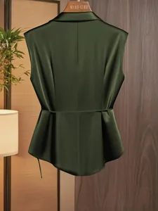 Back view of an elegant dark green satin sleeveless blouse with a waist tie detail.