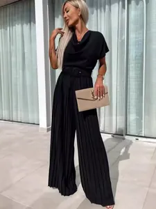 Elegant black pleated wide-leg jumpsuit for women featuring a matching waist belt.