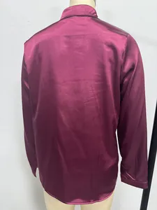 Detailed back view of a glossy maroon satin long-sleeved shirt displayed on a mannequin