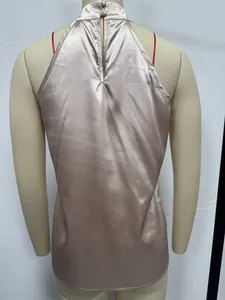 Back view detail of a champagne satin halter neck sleeveless top on a mannequin