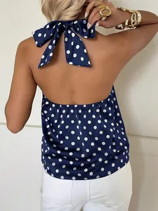 Detailed back view of a navy blue polka dot halter top with neck tie and backless design.