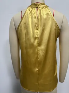 Detailed back view of a gold satin halter neck sleeveless top displayed on a mannequin