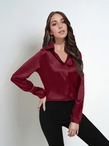 Close-up of elegant burgundy satin long-sleeve blouse with subtle sheen