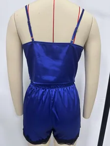 Detail back view of blue satin camisole and shorts pajama set with black lace trim