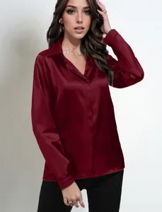 Detail view of burgundy satin long-sleeve shirt with silky texture and elegant collar