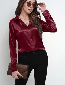 Detailed view of an elegant burgundy satin long-sleeved shirt with a glossy finish for women.
