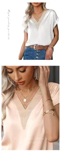 Detail eines Damen Satin-Oberteils mit V-Ausschnitt, Spitze und glatter Stoffstruktur